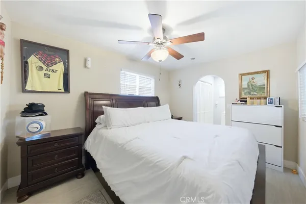 a bedroom with a bed and a chandelier