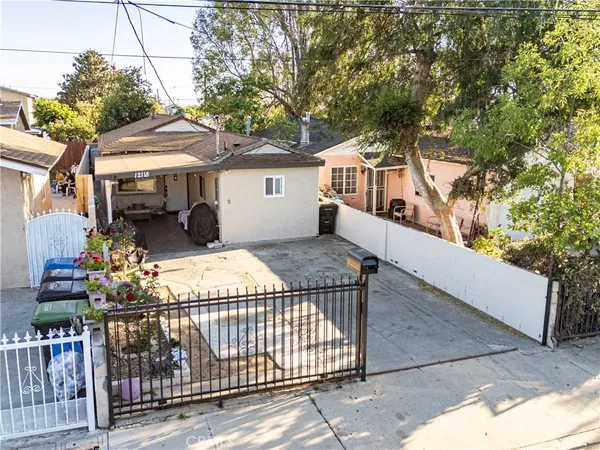 a view of a house with wooden fence