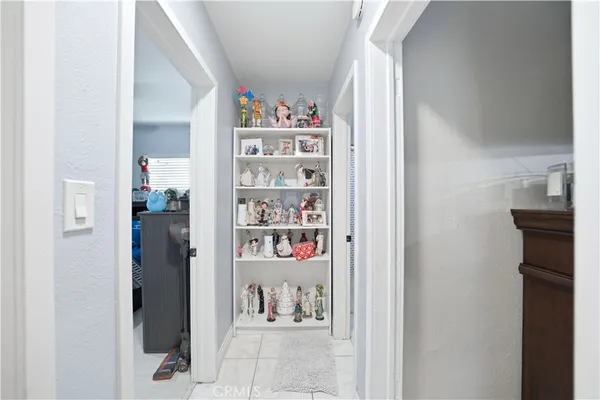 a bedroom with a bed a dresser and a chandelier