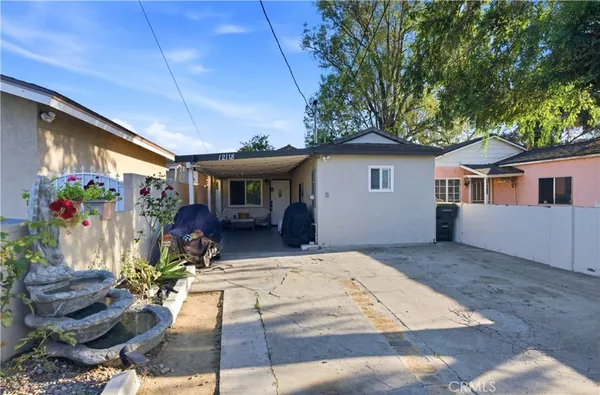 a picture of a house with outdoor seating