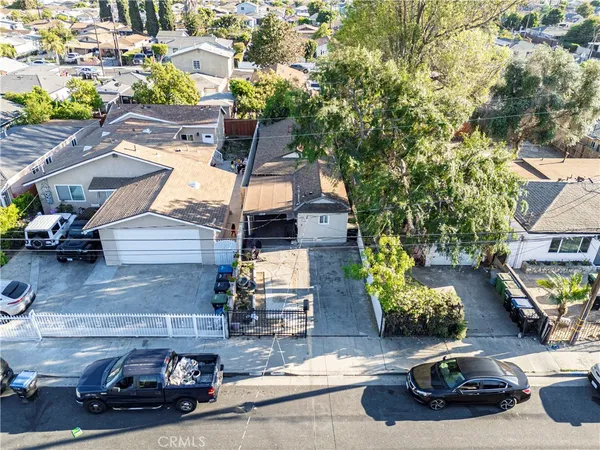a view of a house with wooden fence