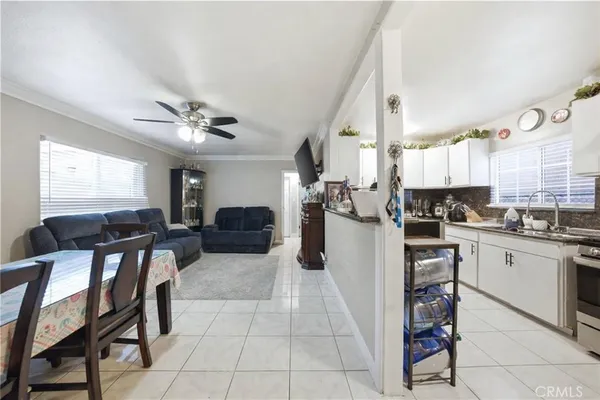 a kitchen with cabinets and chairs