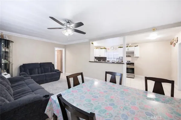 a living room with furniture and kitchen view