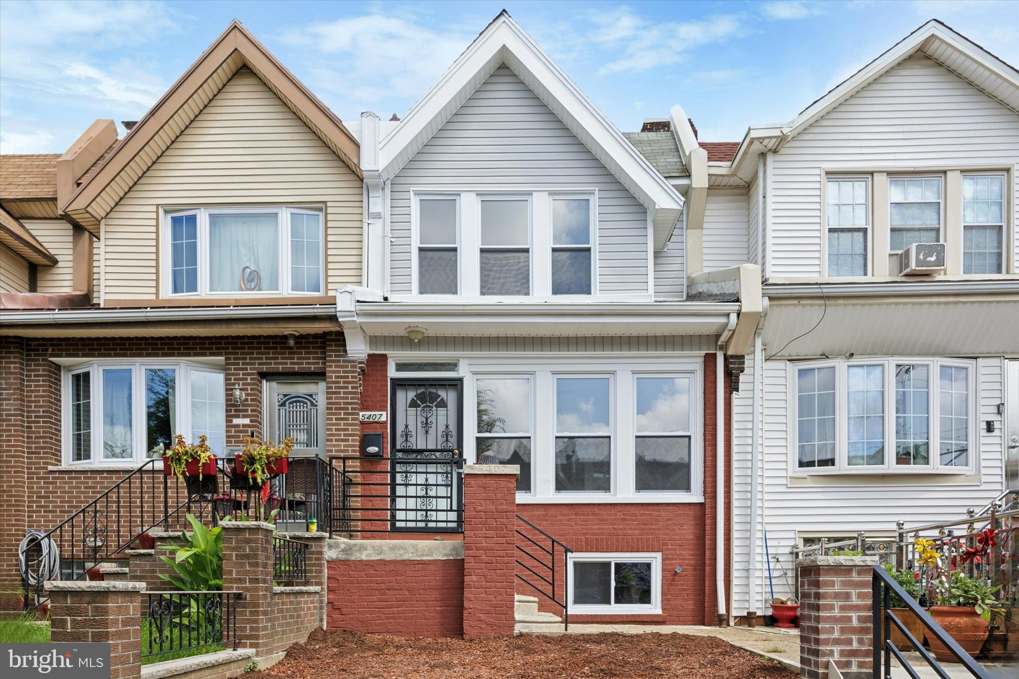 5407 Arlington Street Philadelphia, PA 19131 - Photo 1 of 15 a view of a brick house with large windows and plants