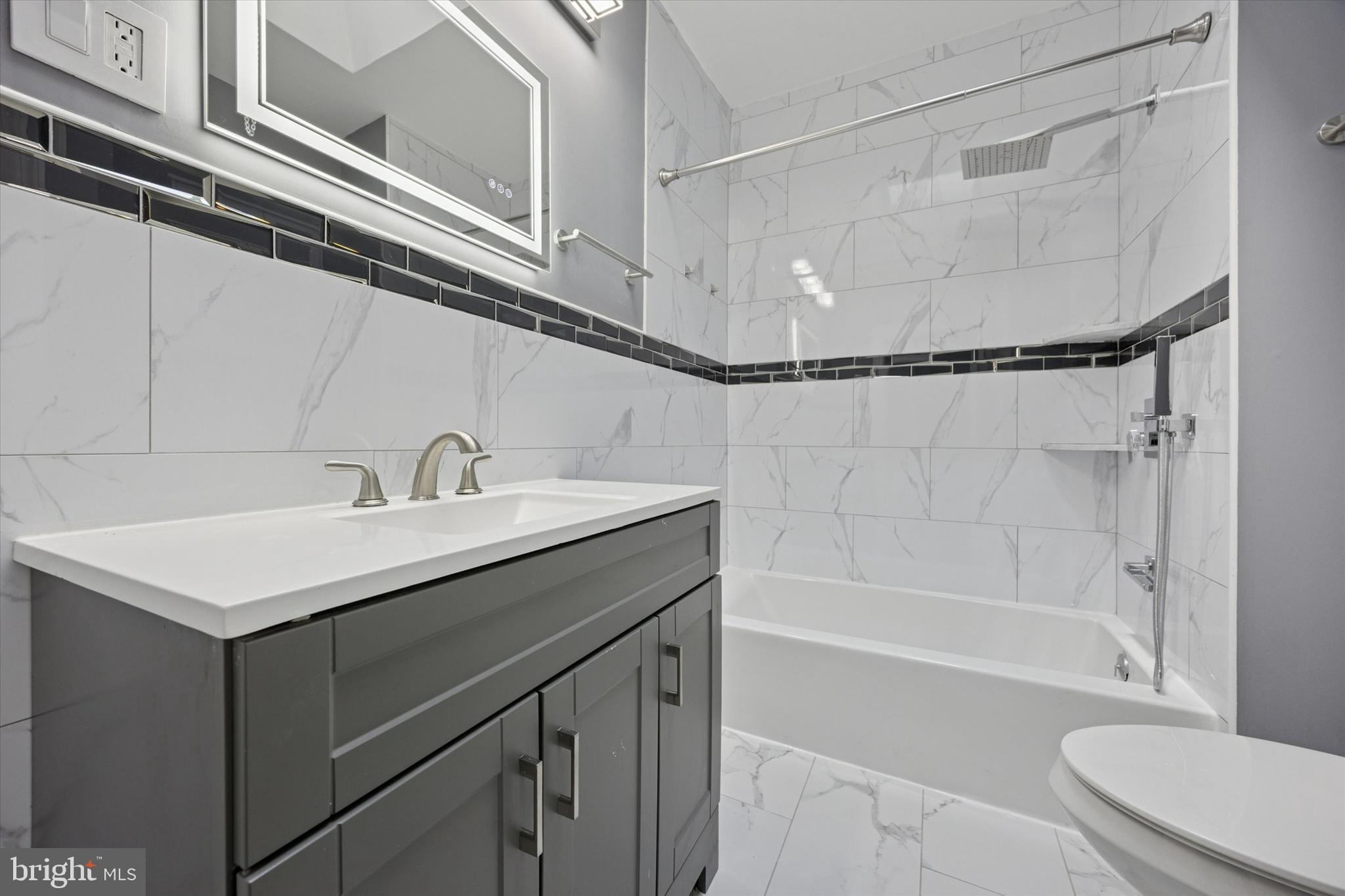 5407 Arlington Street Philadelphia, PA 19131 - Photo 12 of 15 a bathroom with a sink a toilet and shower