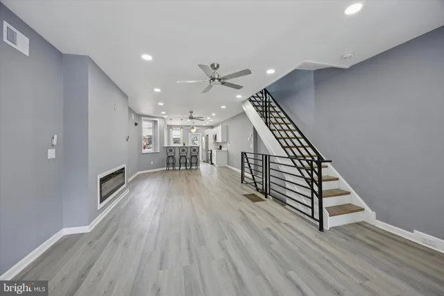 a view of entryway and hall with wooden floor