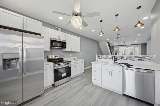 a kitchen with a sink stainless steel appliances and cabinets