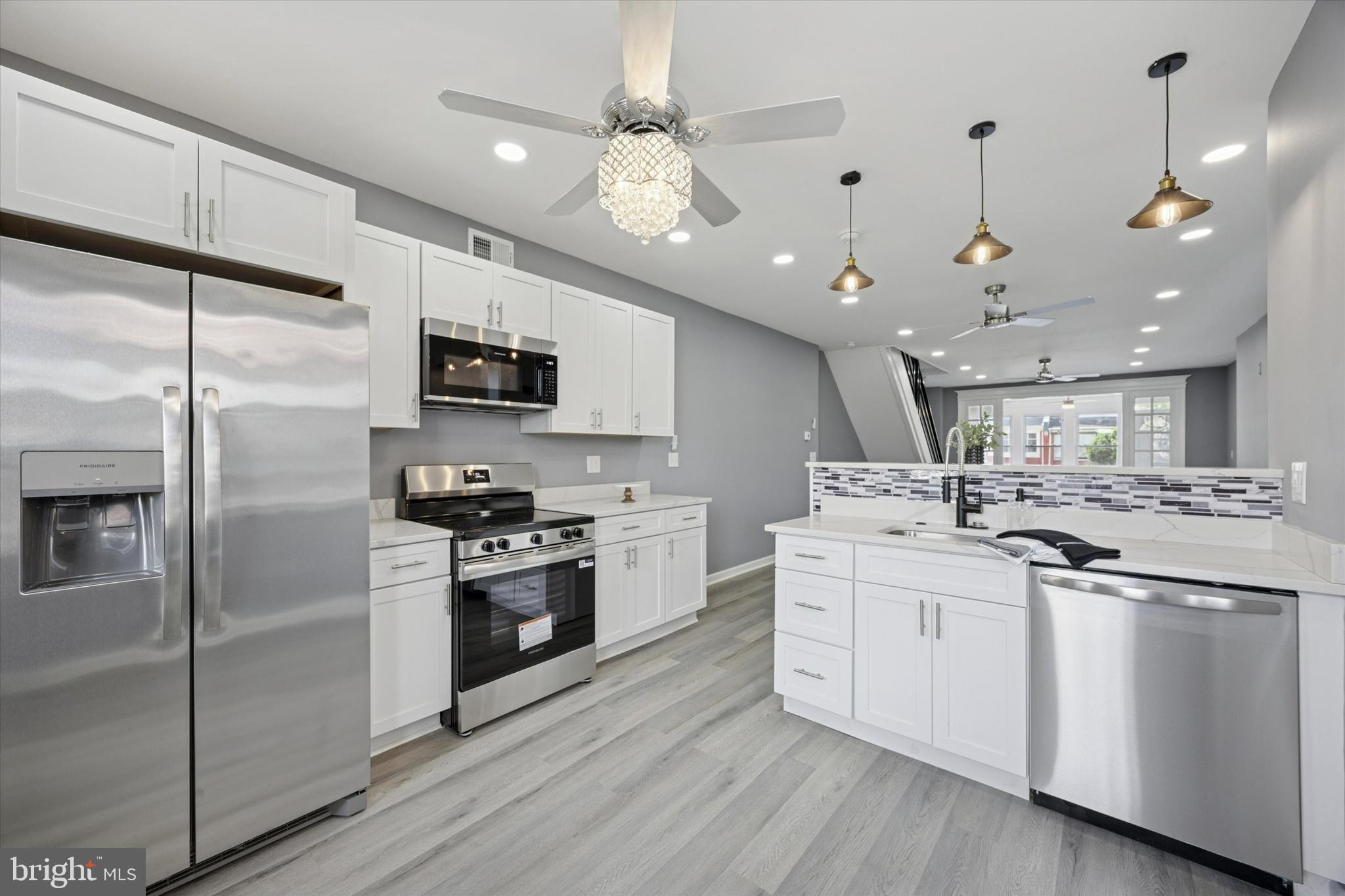 5407 Arlington Street Philadelphia, PA 19131 - Photo 7 of 15 a kitchen with a sink stainless steel appliances and cabinets
