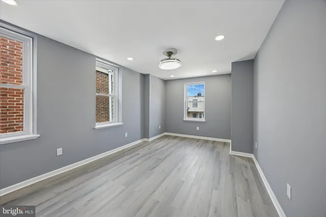 an empty room with windows and closet