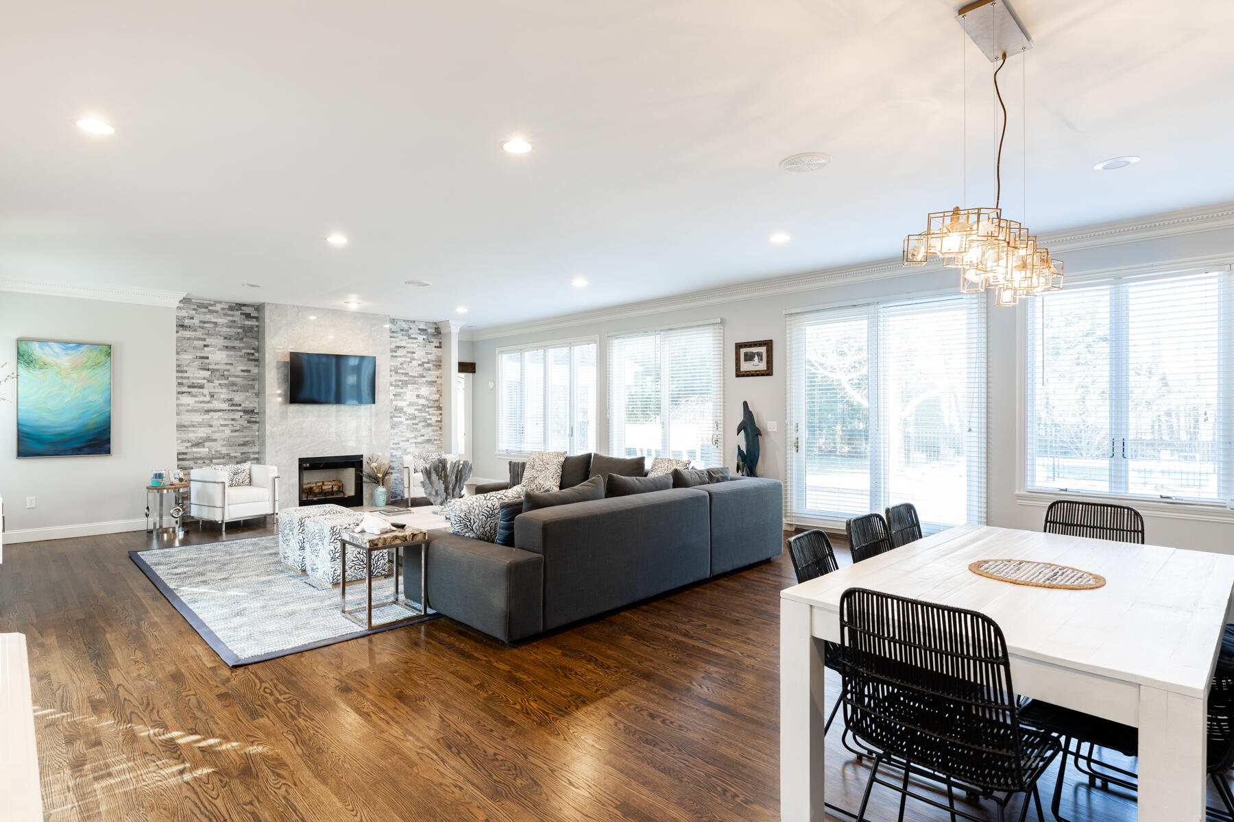 135 Paddock Circle Mashpee, MA 02649 - Photo 12 of 60 a living room with fireplace furniture and a chandelier