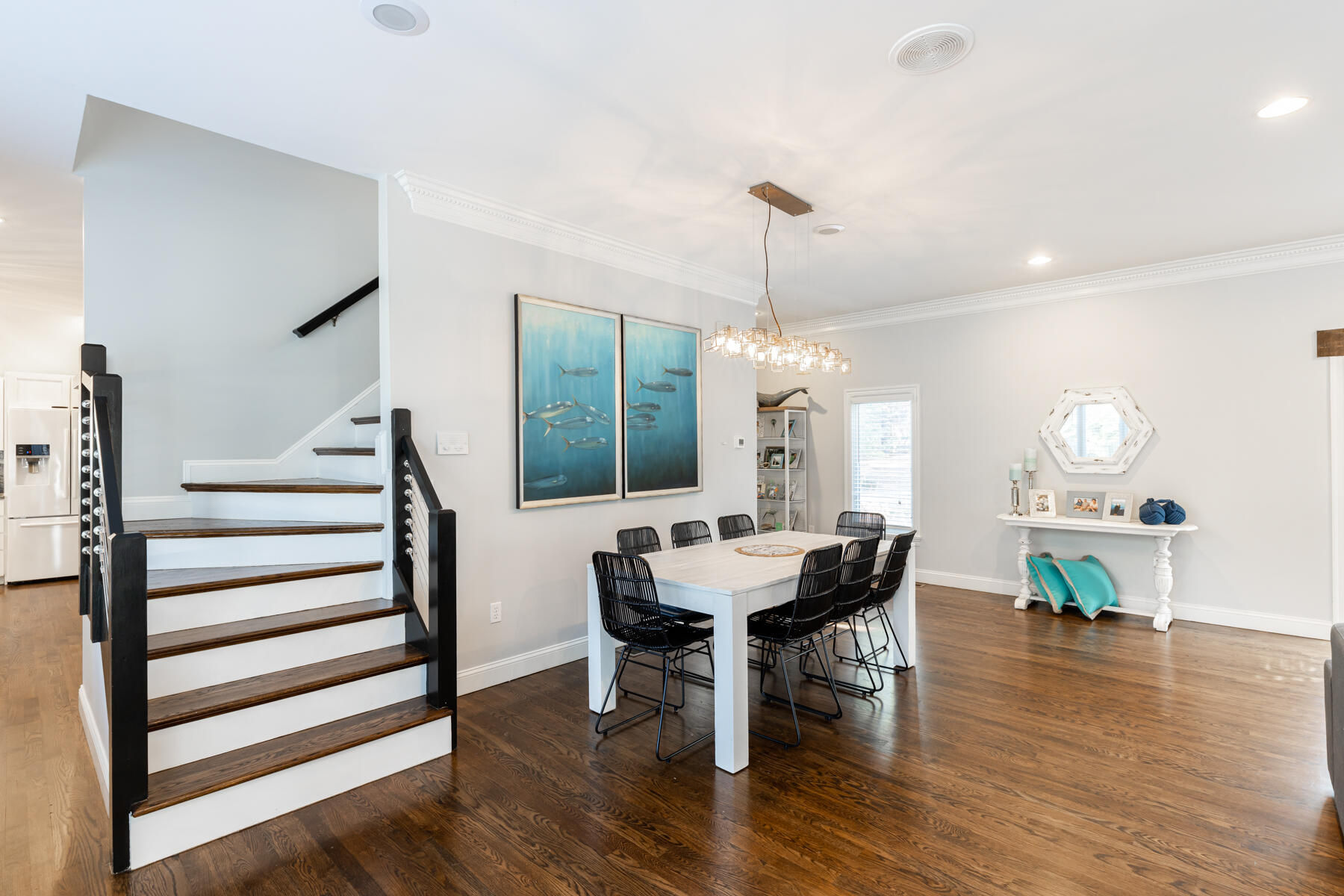 135 Paddock Circle Mashpee, MA 02649 - Photo 13 of 60 a view of a dining room and livingroom with furniture wooden floor a chandelier