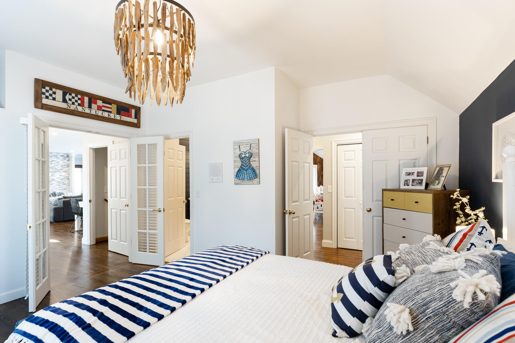 135 Paddock Circle Mashpee, MA 02649 - Photo 24 of 60 a bedroom with a bed and a chandelier