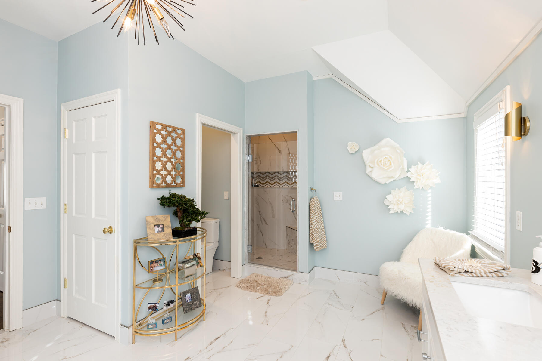 135 Paddock Circle Mashpee, MA 02649 - Photo 34 of 60 a bedroom with a bed and a chandelier