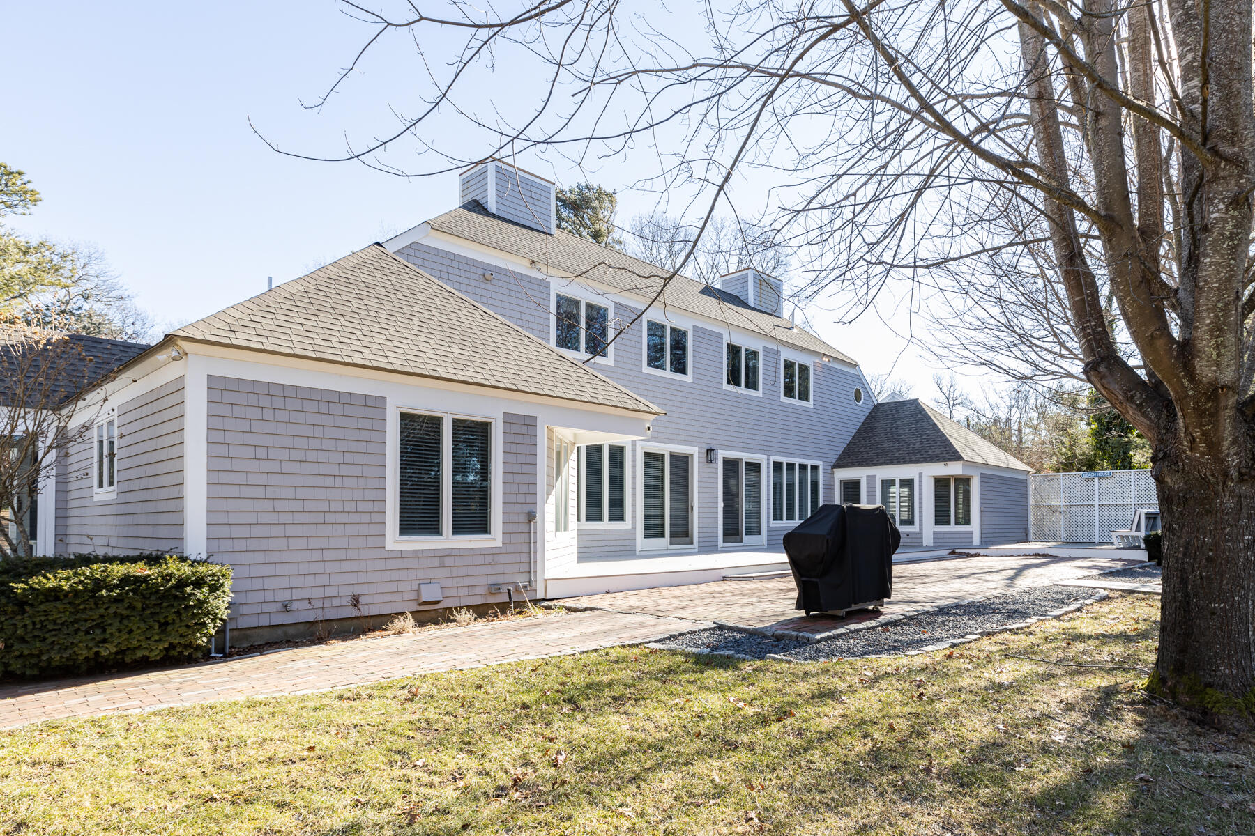 135 Paddock Circle Mashpee, MA 02649 - Photo 51 of 60 a front view of a house with a yard covered in snow