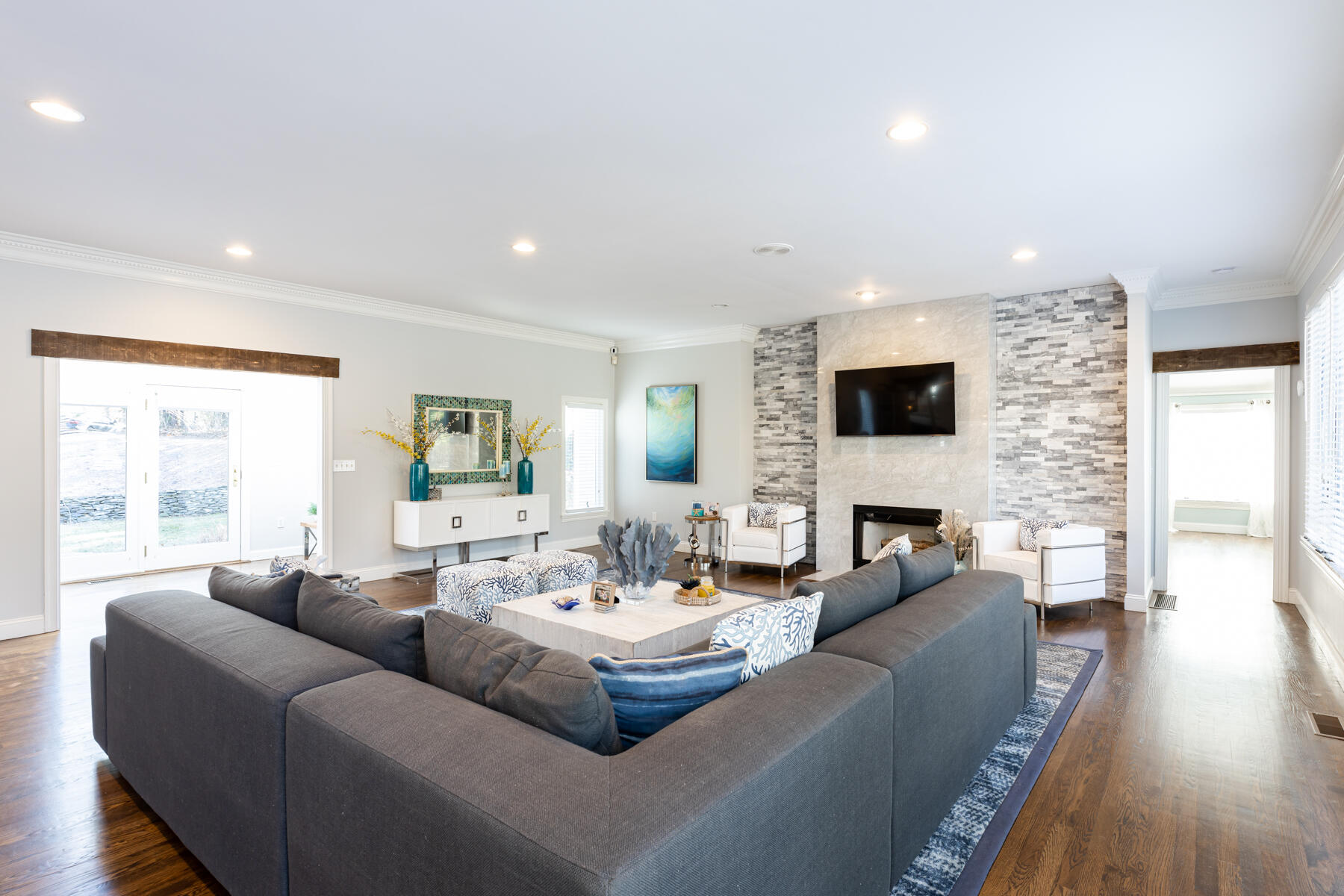 135 Paddock Circle Mashpee, MA 02649 - Photo 9 of 60 a living room with fireplace furniture and a large window