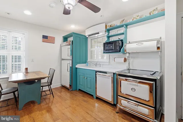 a kitchen with a stove a sink and a refrigerator