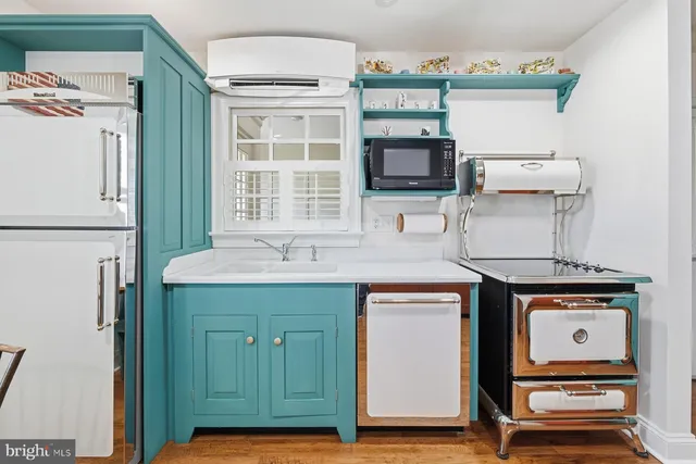 a kitchen with a refrigerator and a stove