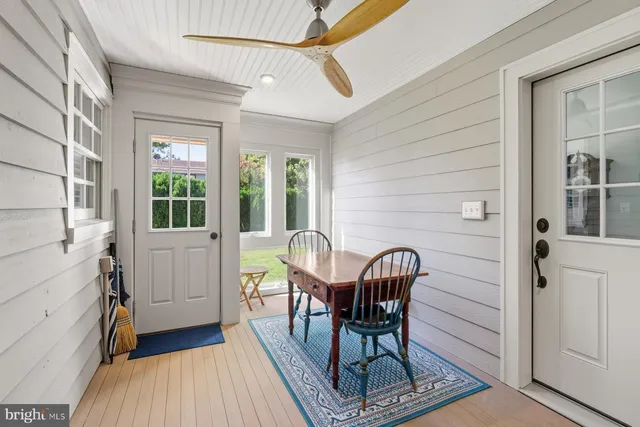 a view of a chair and table in the back of the house