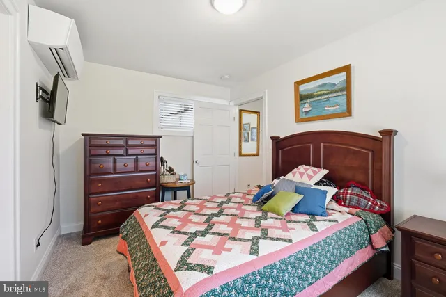 a bedroom with a bed and a dresser