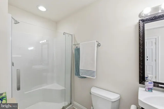 a bathroom with a shower a toilet and sink