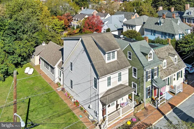 an aerial view of multiple houses with yard