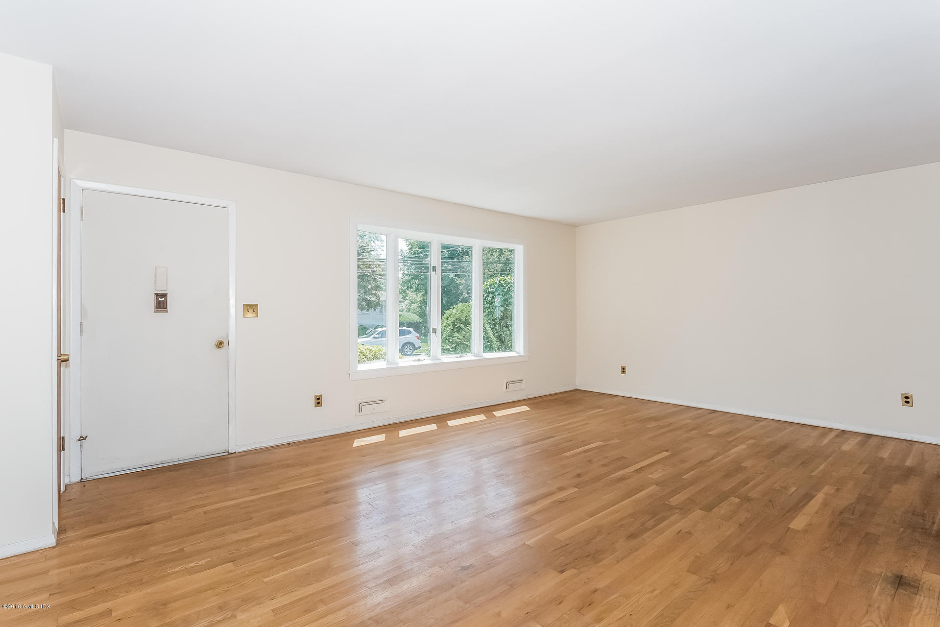 15 Amherst Road Riverside, CT 06878 - Photo 4 of 27 a view of an empty room with wooden floor and a window