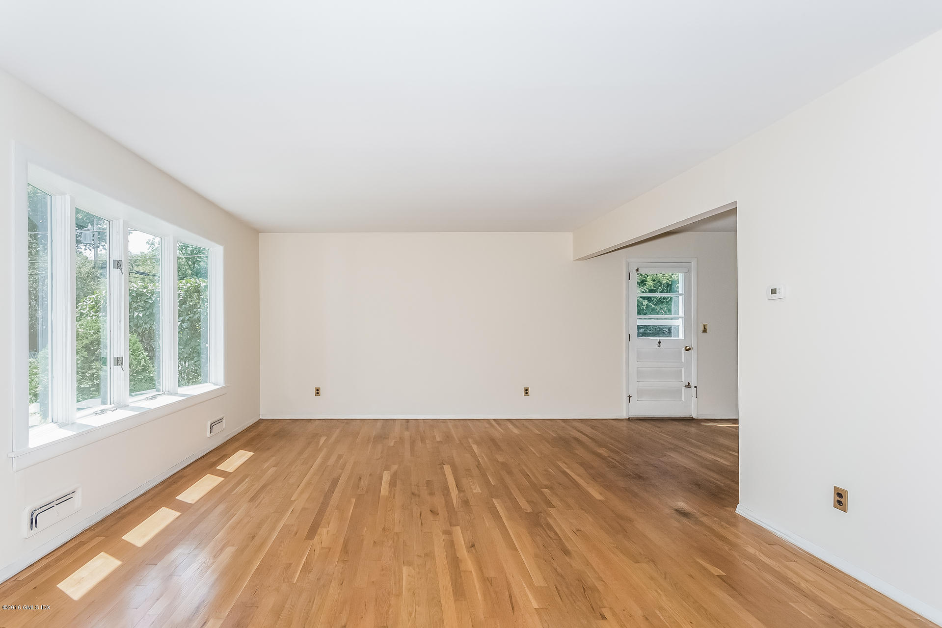 15 Amherst Road Riverside, CT 06878 - Photo 5 of 27 an empty room with wooden floor and windows