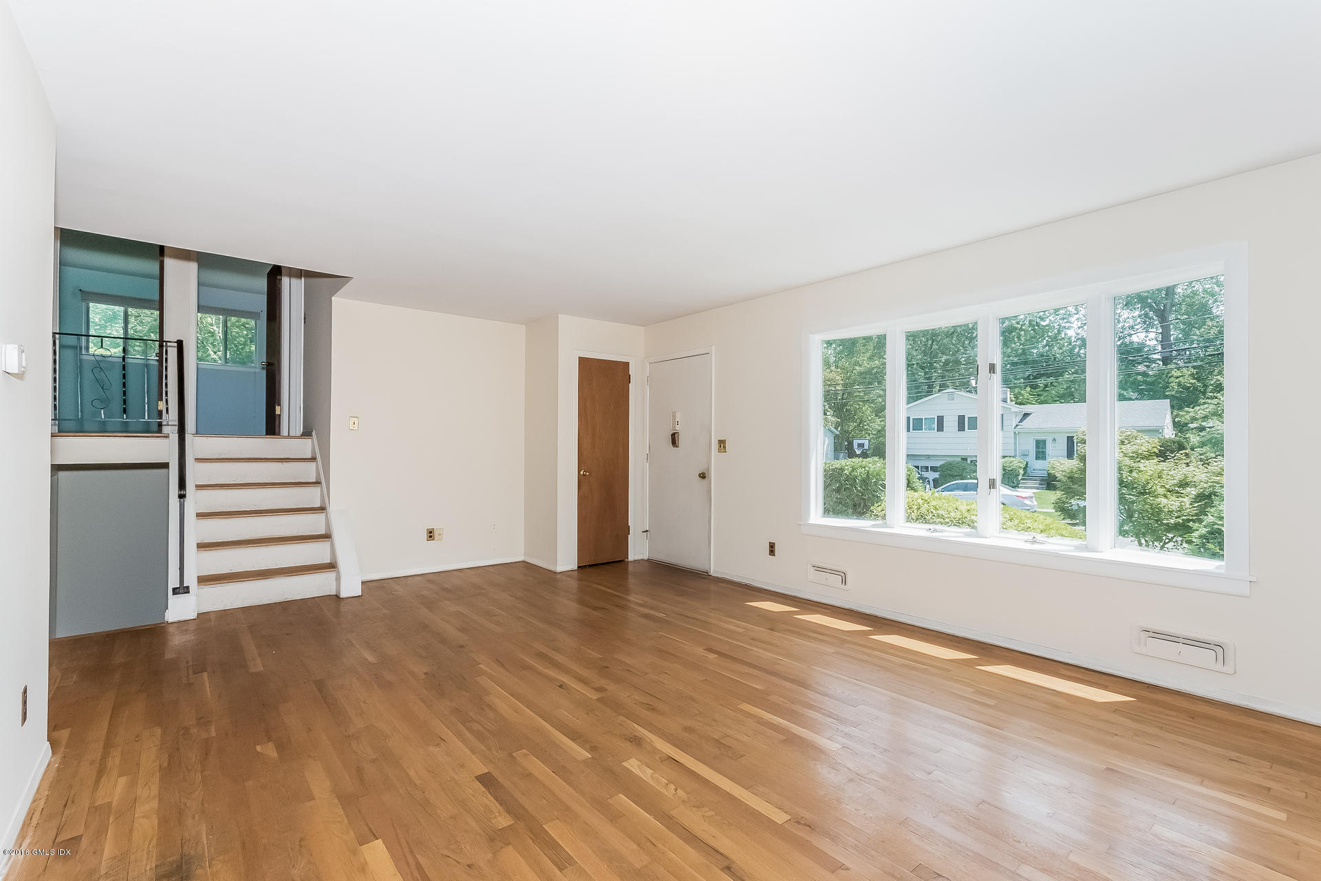 15 Amherst Road Riverside, CT 06878 - Photo 6 of 27 an empty room with wooden floor and windows