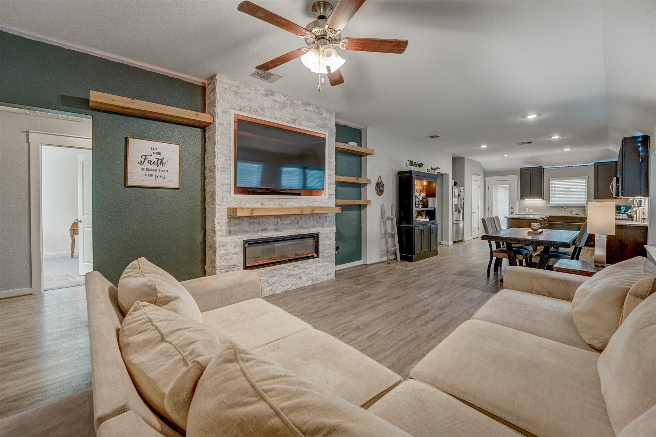 5806 Aviano Road Round Rock, TX 78665 - Photo 12 of 29 An inviting great room with an integrated kitchen offers a modern fireplace and ample space for relaxation.