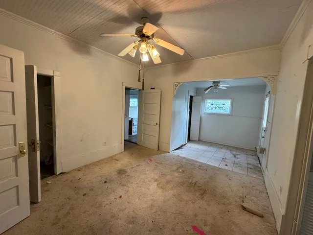 a front view of house with yard and trees in the background
