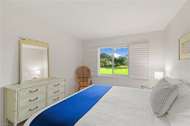 a bedroom with a bed and a dresser in it