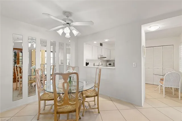 a view of a dining room with furniture and chandelier fan