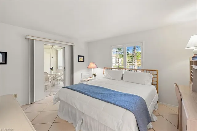 a bedroom with a bed and a table