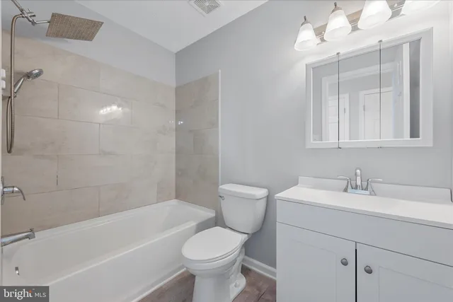 a bathroom with a sink a toilet and bathtub