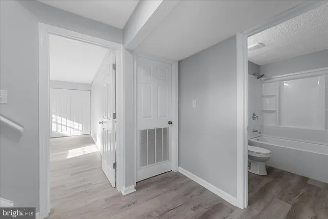 a bathroom with a granite countertop toilet and a shower