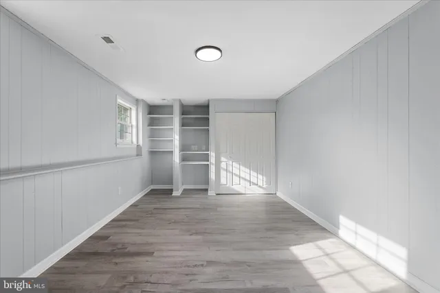 a view of an empty room with closet