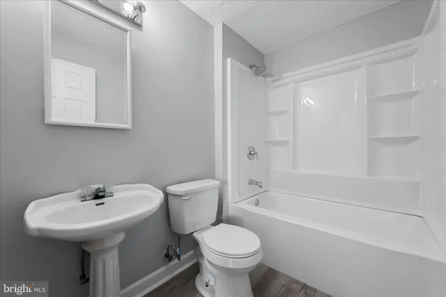a bathroom with a sink toilet and a bathtub