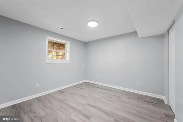 a view of a wooden fence under a large tree