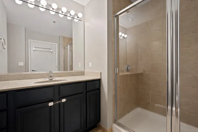 a bathroom with double sink and a mirror