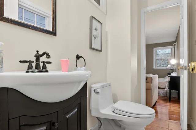 a bathroom with a sink a toilet and a mirror