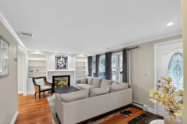 a living room with furniture fireplace and a table