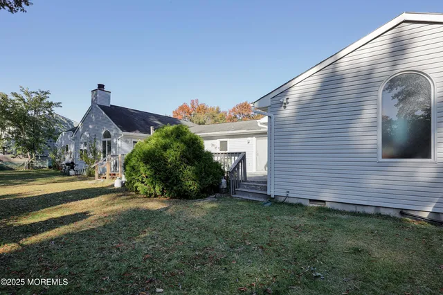a view of a patio with table and chairs with wooden floor and fence