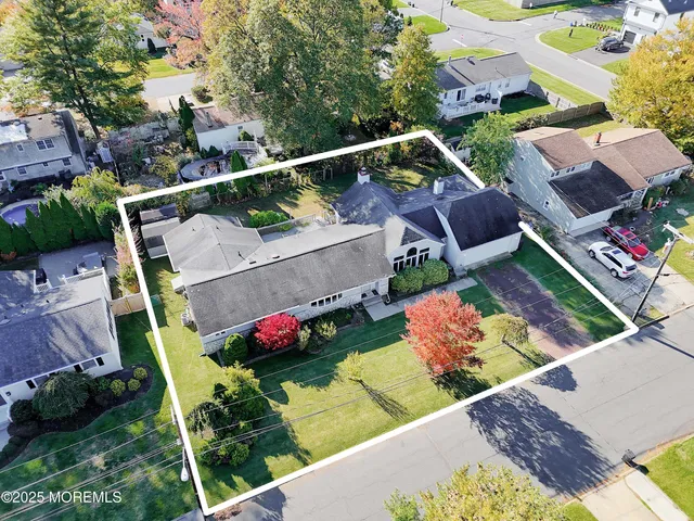 an aerial view of a house with yard swimming pool and outdoor seating