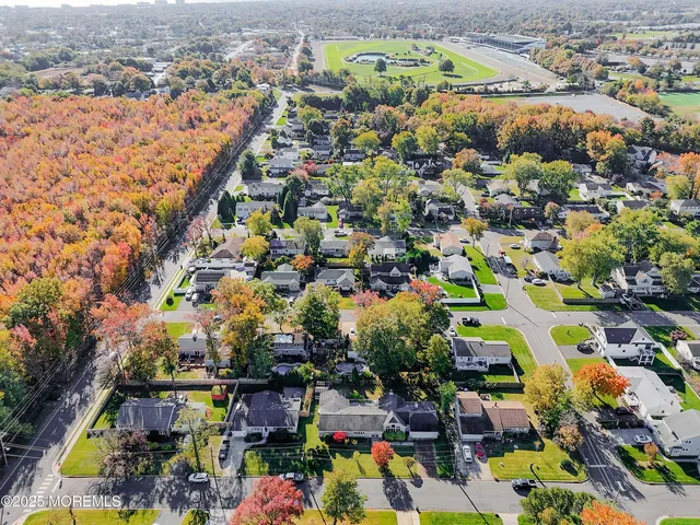 a view of a patio with table and chairs with wooden floor and fence