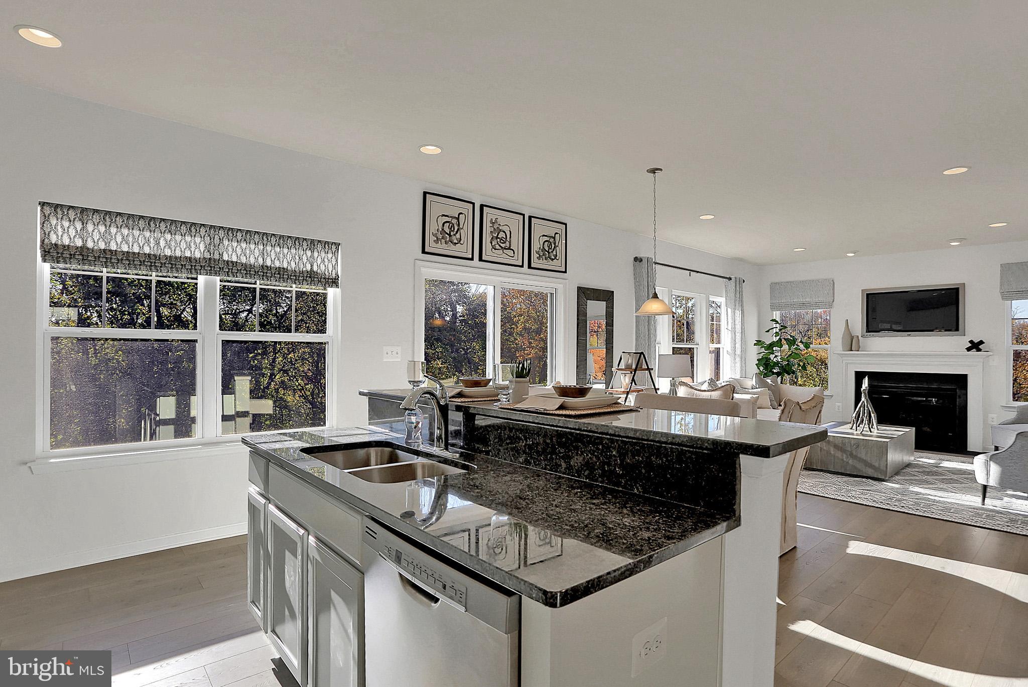111 Nell Street Perryville, MD 21903 - Photo 12 of 22 a kitchen with a stove a sink and a dining table with wooden floor