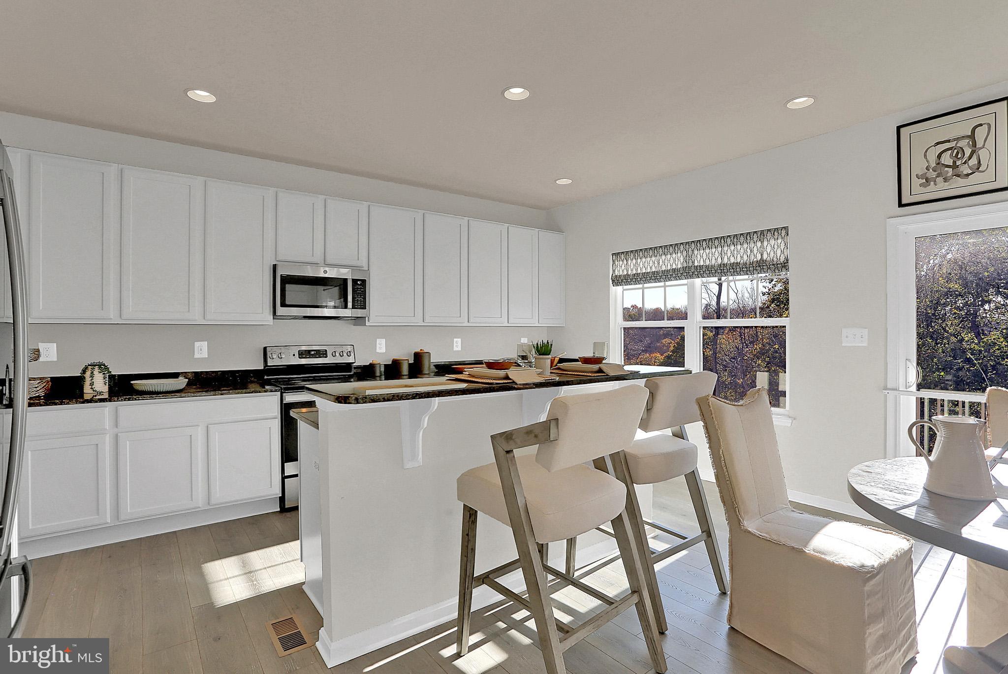 111 Nell Street Perryville, MD 21903 - Photo 13 of 22 a kitchen with white cabinets and appliances