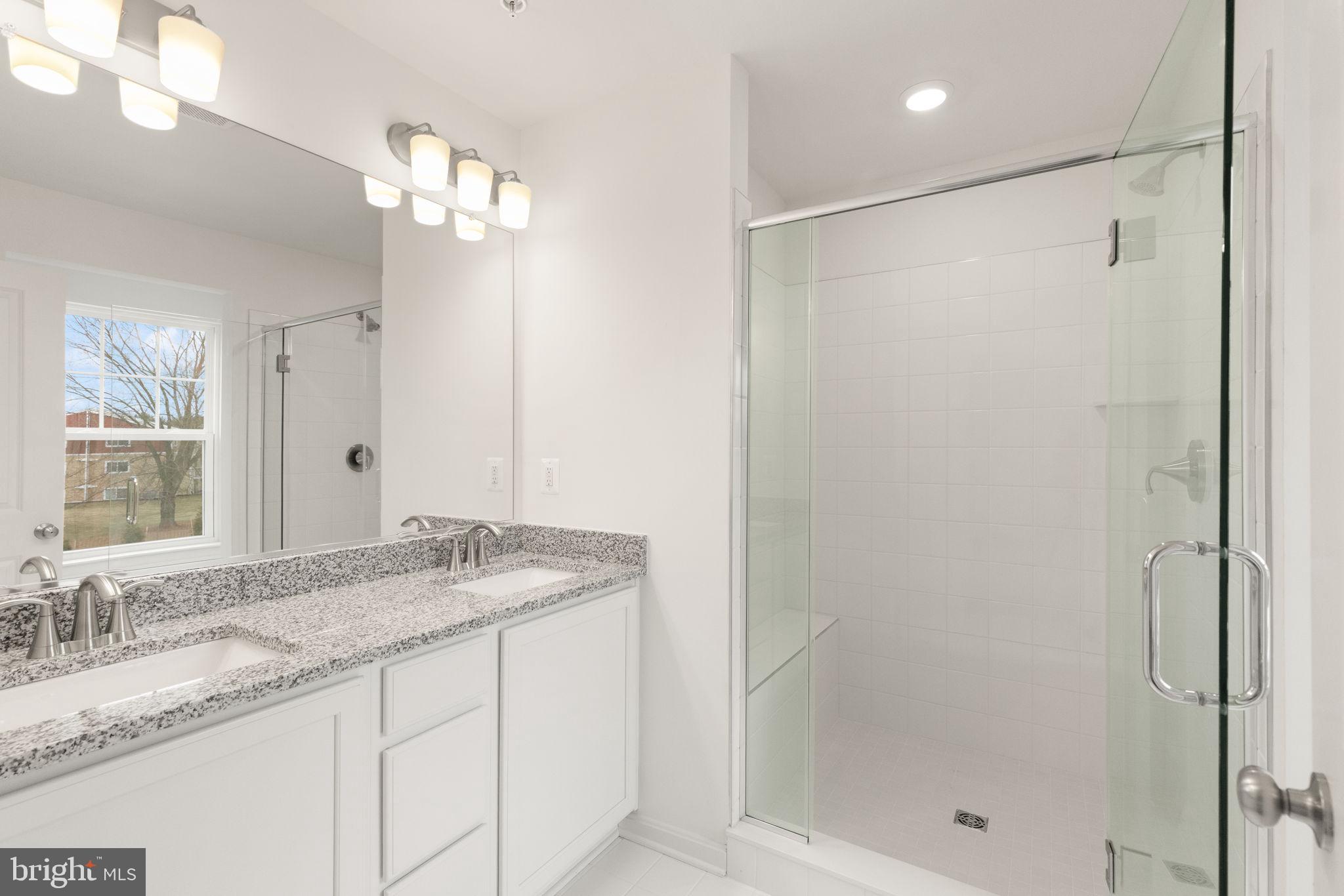 111 Nell Street Perryville, MD 21903 - Photo 24 of 29 a bathroom with a granite countertop sink a shower and a mirror