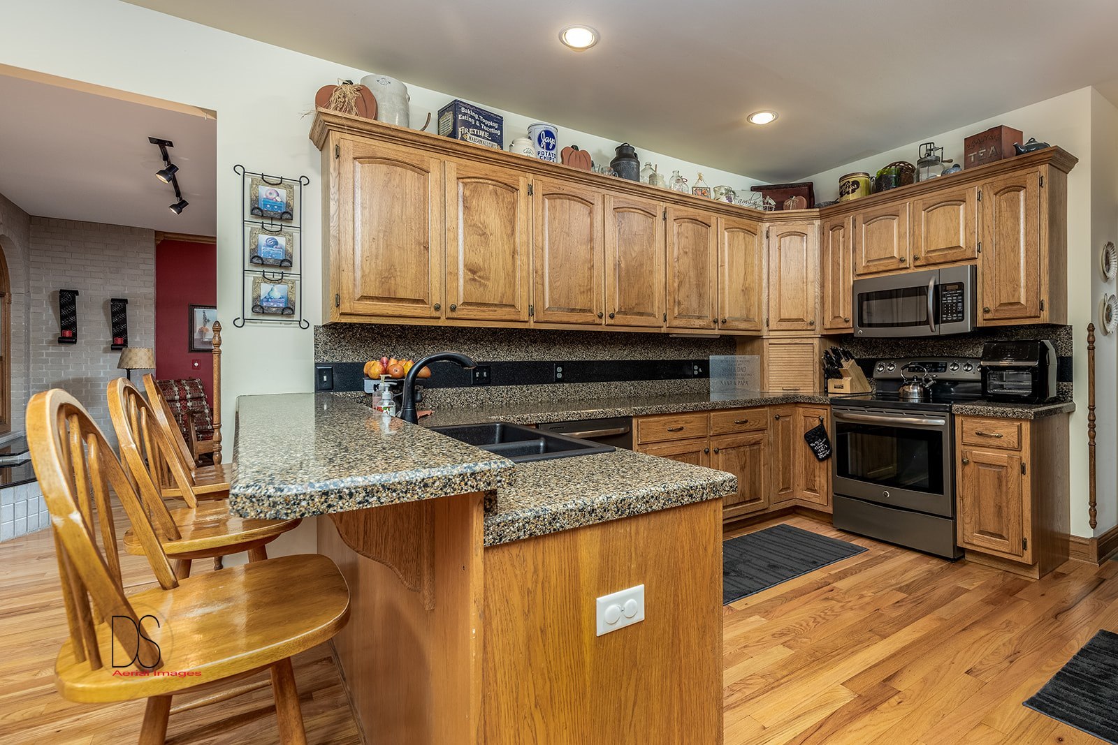 1777 North 3604th Road Ottawa, IL 61350 - Photo 14 of 36 a kitchen with stainless steel appliances granite countertop a stove top oven a sink dishwasher and microwave oven with wooden floor