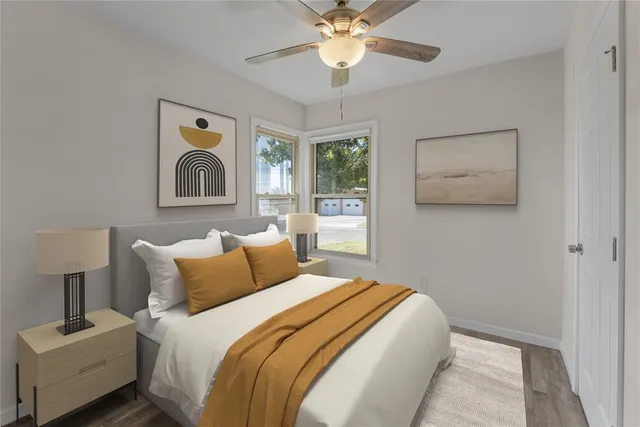 a bedroom with a bed and painting on the wall