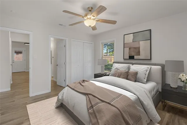 a spacious bedroom with a bed and a ceiling fan